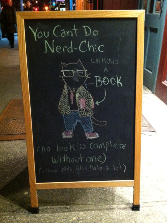 To be a Cool Cat and carry off Nerd Chic, you need a book plus, like, maybe an iPad?