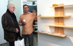 Talking shop with a potential client, Cambium Studio's founder Mark Righter, with coffee, is next to his shelves with sliding dovetails. (Brooklyn Artisan Photo Pool/ams)